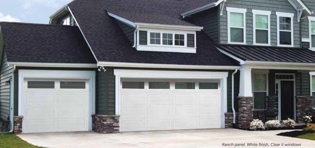 Modern residential home with white garage doors